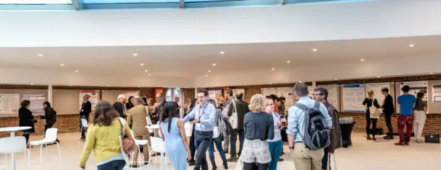 Image of group of delegates chatting in the Exhibition Space