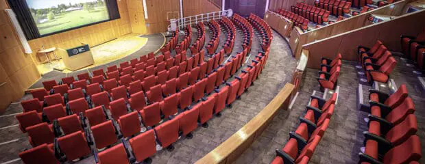 View of large part of the Francis Crick Auditorium taken from the top left, towards the stage.